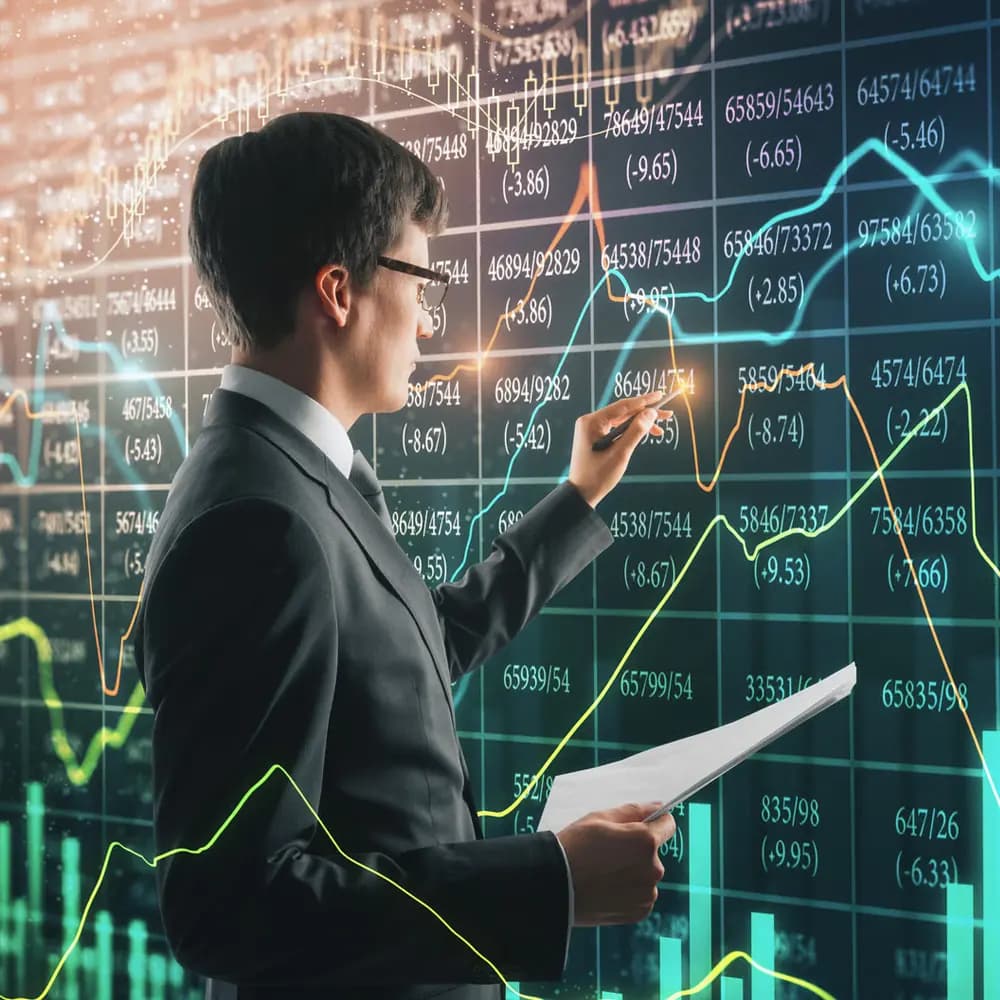 Analyst charting data on a glass board